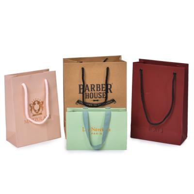 China Custom Luxury Kraft Paper Bags Clothing Recyclable Printed Logo Packaging Paper Shopping Paper Bag for sale