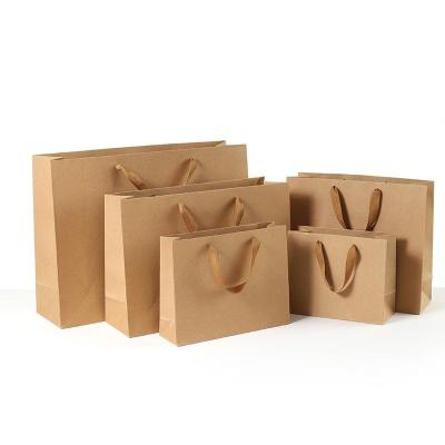 China Recycled Materials Wholesale Low Cost Paper Craft Bag Price Kraft Paper Clothing Bags Used For Shopping Packaging Of Various Products for sale