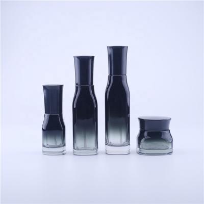 China New Quartet Gradient Personal Care Cosmetics Black Glass Essence Lotion Pump Sprayer Cream Packaging Bottle With Wood Grain Cover for sale