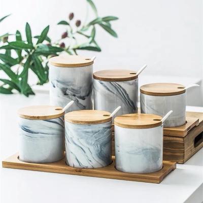 China Viable Luxury Fancy Wholesale Empty Ceramic Spice Containers Kitchen Style Lid Marble Wooden Spice Jar With Bamboo Rack for sale