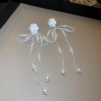 China Romantic Silver Korean Design Dangle Earrings Natural Wind Camellia Needle Pearl Bow Tassel Earrings Forest Earrings for sale