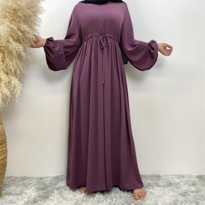 China Polyester Muslim minimalist design solid color rubber band sleeves, neckline zipper, elegant large hem dress for sale