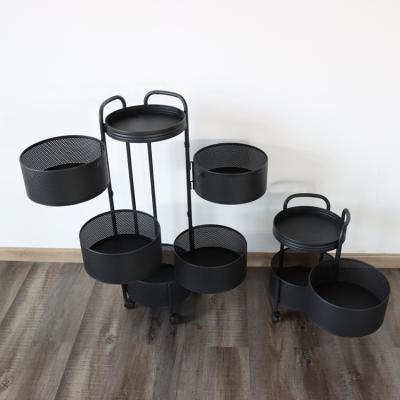 China Sustainable round type black multi-function vegetable metal sundries floor fruit turn storage rack kitchen for sale