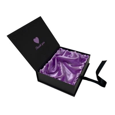 China Custom Recyclable Magnetic Foldable Rigid Cardboard Paper Black Logo Hair Extension Packaging Wig Boxes With Purple Silk Interior for sale