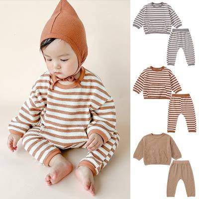 China Autumn Spring Infants and toddlers unisex anti-shrink cotton waffle baby striped pocket suit long sleeve pajamas for kids dress up sets for sale