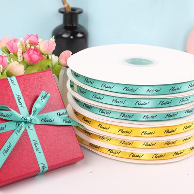 China Recyled customized 1cm black embossed logo printing color high quality polyester satin ribbon for gift box packing decoration for sale