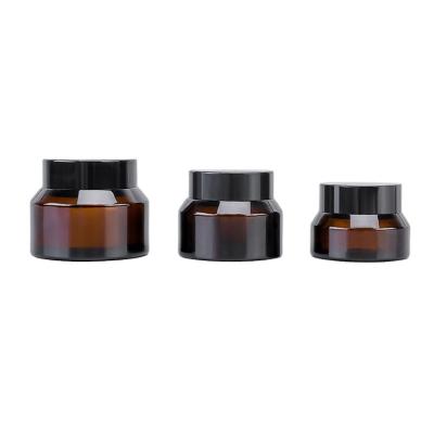 China 15g 30g 50g /empty Round Shape Cosmetic Jar Cosmetic Amber Black Glass Container Cream Jars With Black Lid for sale