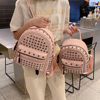 China Fashion Waterproof Wholesale Size PU Leather Teenage Girls Big And Small Two Shape Female Rivet Bagpack School Bag Mini Backpack for sale