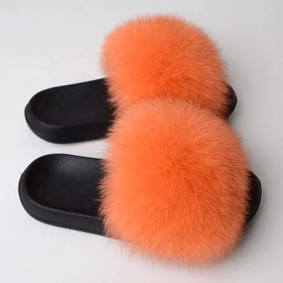 China Fashion trend fashion trend wholesalers real fox fur fiuffy pom poms cheap sandals slippers and fashionable soft raccoon fur slippers for kinds of women for sale