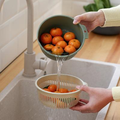 China Double Seated Kitchen Colander Washing Large Sink Ball Sustainable Plastic Rolling Strainer Rotating Drain Basket for sale