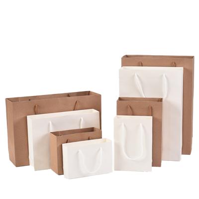 China Recyclable Free Logo Printing Waterproof White Kraft Paper Gift Packaging Bags With Handle For Shopping for sale