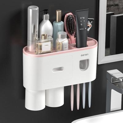 China New Fashion Creative Plastic Automatic Toothpaste Dispenser 2 Cup Magnetic Toothbrush Wall Mounted Holder Without Punching for sale