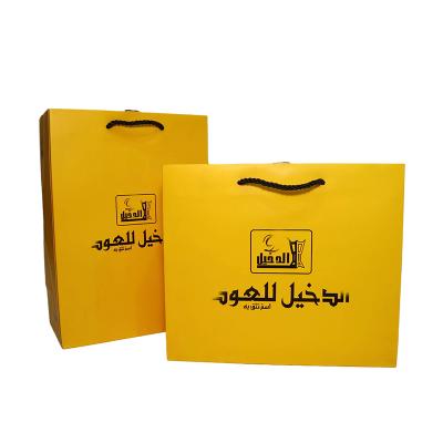 China Recyclable Custom Yellow Logo Printing Square Bottom Fashion Gift Retail Shopping Paper Bags With Thick Nylon Rope Handle for sale