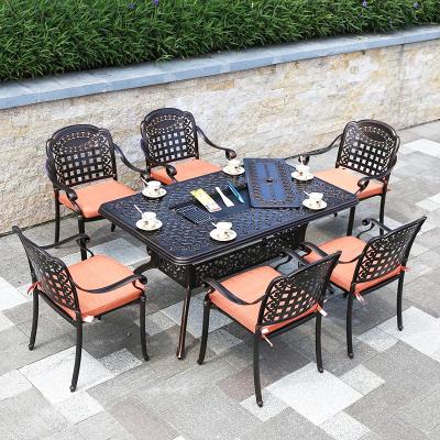 China Traditional Cast Iron Cafe Furniture Wrought With Cushion Family Party Iron Metal Dining Sets Sectionals Garden Table Chairs for sale