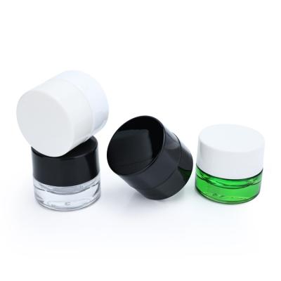 China Low Profile Cosmetic 5ml Empty White Ceramic Kid 5 Gram Containers Small Mini UV Resistant Black Glass Jar With Plastic Lids for sale