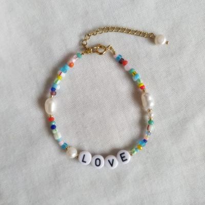 China Custom Made Titanium Steel Rainbow Pearl Letters Freshwater Bracelet Ladies Casual/Sporty for sale