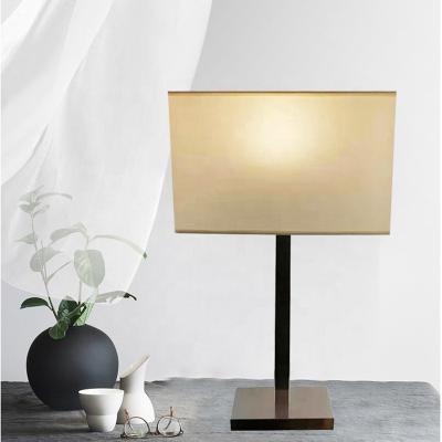 China Modern Stainless Steel Stock Emptying Table Lamp With Fabric Shade Hotel Beside Lamp for sale