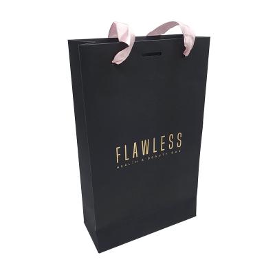 China Recyclable black gold LOGO rose bow ribbon paper card stamping handbag is suitable for jewelry, small items and gift packaging for sale