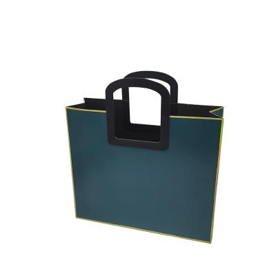 China Simple And Generous Recyclable Plastic Shopping Creativity Handle Portable Paper Bag For Cosmetics And Clothes Gift Box for sale