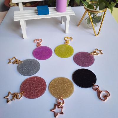 China Full plastic round glitter colorful acrylic keychains with pom pom with pompom for sale