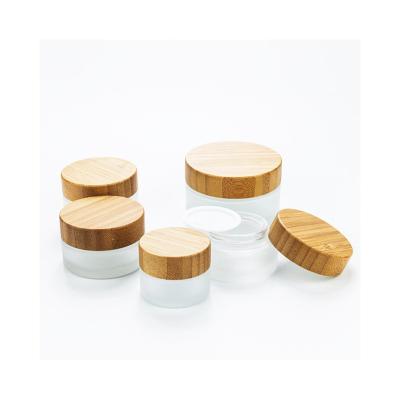 China Cosmetic Frosted transparent glass jar with bamboo lid glass bamboo jar bamboo cosmetic packaging for sale