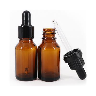 China Cosmetic Round shape cosmetic glass eamber sential oil glass bottles high end essential oil empty bottle for sale