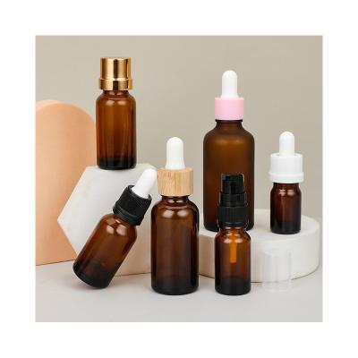 China Cosmetic 10ml 15ml 30ml 50ml 100ml Amber glass circular essential oil bottle bottom essential oil bottles for sale