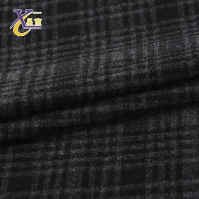 China OEM 260gsm durable elastic terylene rayon texture black check knitted jacquard apparel fabric for coat for sale