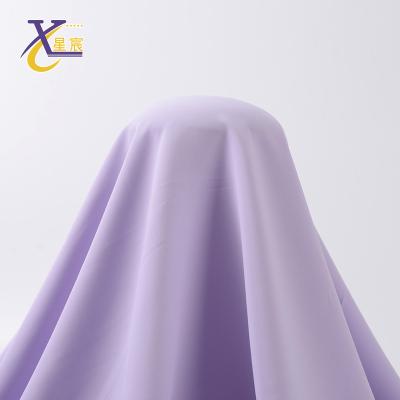 China Other Xingchen factory stock ready to ship garment material 100 polyester solid color fabric price per meter for sale