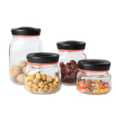 China Viable Round Jam Glass Storage Bottle Glass Food Jar For Storing Honey Snack Cookies With Black Lid for sale