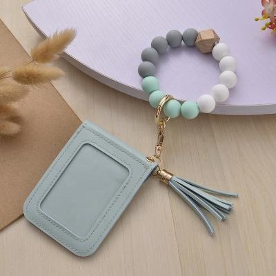 China NEW Design Eco-friendly Silicone Tassel Bracelet Wooden Bracelet Beads Key Chain Gift for sale