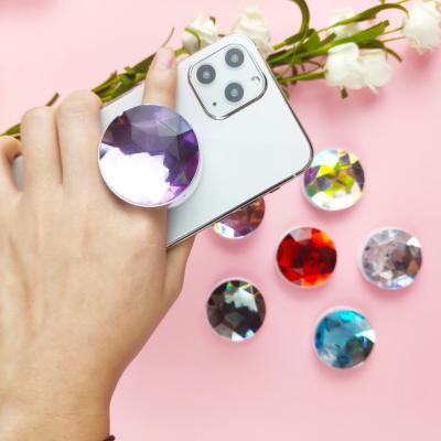 China Shiny Overized Diamond Popular Cell Phone Sockets Promotion White 2021 Rotating Gift Plastic Phone Grip Holder New for sale