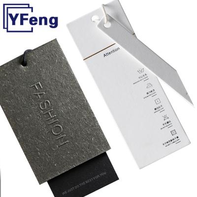 China LOGO Emboss Printing Clothing Garment Washable Recycled Gift Card Kraft Craft Paper Cardboard Swing Customized Hang Tag With String for sale