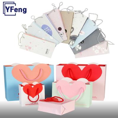 China Cheap Recyclable Emboss Hot Stamping Deboss Print Custom Design Logo Reusable White Wedding Gift Cardboard Kraft Paper Bag With Handle for sale