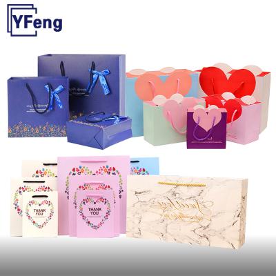 China Recycled Materials Wholesale Emboss Deboss Hot Stamping Print Customized Own Logo White Shopping Gift Cardboard Kraft Paper Bag With Handle for sale