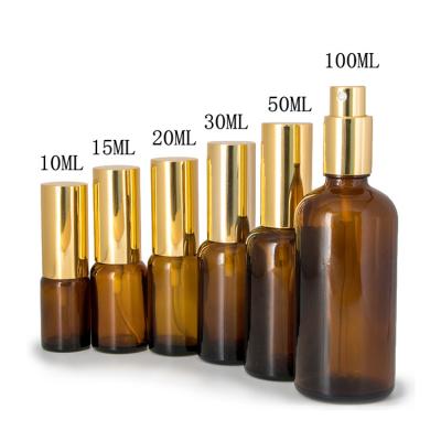 China High quality recyclable 5ml 10ml 15ml 20ml 30ml 50ml 100ml frosted gold glass essential oil bottles with gold silver spray cap for sale