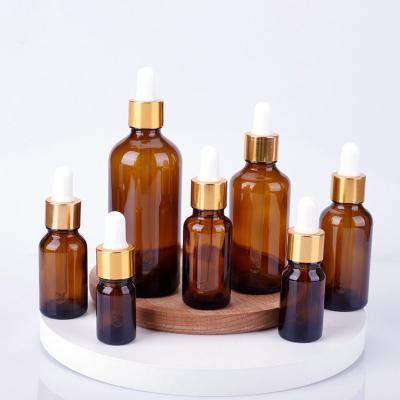 China 5ml 10ml 15ml 20ml 30ml 50ml 100ml Amber Glass Essential Oil Cosmetic Bottle With Gold Aluminum Dropper Cap for sale