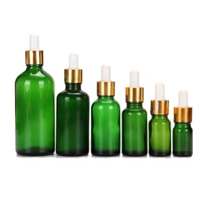 China Recyclable Cosmetic Green Glass Dropper Bottle 10ml 30ml 50ml 100ml Gold Essential Oil Bottle For Packaging for sale