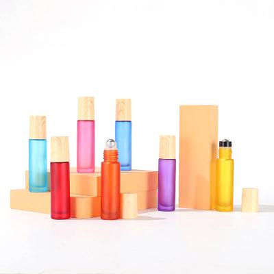 China Cosmetic Wholesale Frosted Matte Rainbow Colors 10ml Roll On Glass Bottle With Grain Cover / Wooden Cap Essential Oil Perfume Bottle for sale