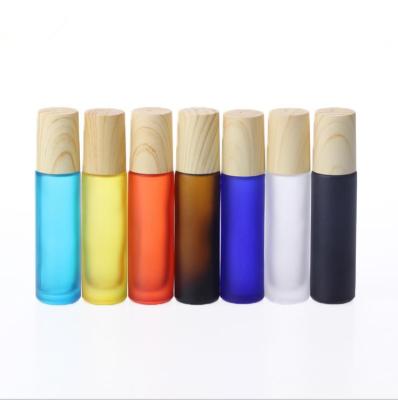 China Recyclable 5ml 10ml Frosted Matte Rainbow Colors Glass Ball Essential Oil Roller Bottle With Wood Grain Lid for sale