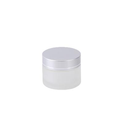 China Custom Wide Mouth Cosmetic Glass Jar Cosmetic Frosted Glass Jar Cream Jar With Silver Lid for sale