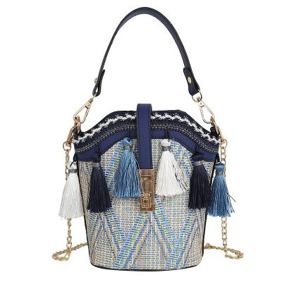 China New Straw Woven Bag Shoulder Bag Flower Vase Chain Handbag Ethnic Style Shell Tassel Bucket Bag Ladies Hadbag High Quality Style for sale