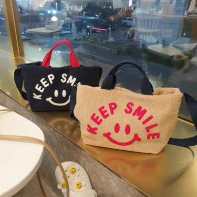 China High-grade Korean style fashion smile plush bag women's messenger women's autumn and winter large-capacity lamb hair shoulder simple cute handbag for sale