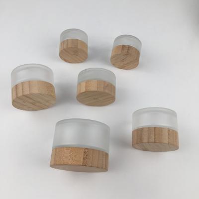 China 5ml 20ml 30ml 50ml 100ml 200ml cosmetic clear frosted empty glass jar with bamboo lids for sale