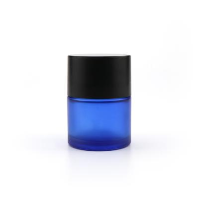 China Wholesale 5ml 50ml 70ml 110ml Empty Light Blue Cosmetic Storage Container Flower Kid Heavy Duty Glass Jar With Black Lids for sale