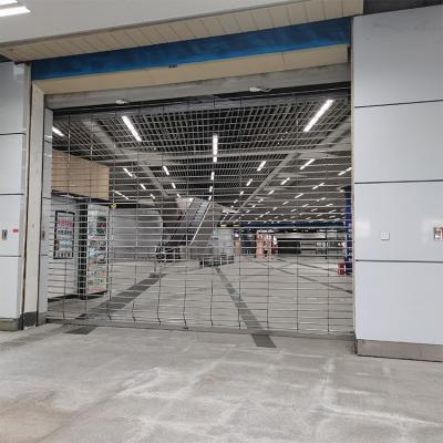 China Security Stainless Steel Grid Hollow Security Central Motor Rolling Gate For Mall for sale