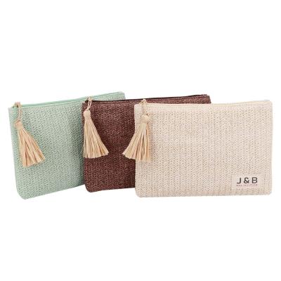 China Summer Natural Tassel Raffia Fashion Magazine Style Straw Material Cosmetic Bag With Fresh Makeup Pouch Special Spring Material for sale