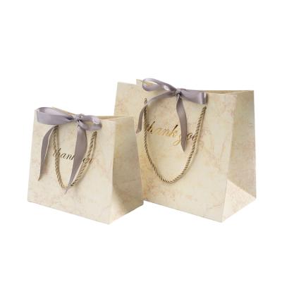 China Wholesale Luxury Recyclable Custom Design Small Ribbon Decoration Paper Favor Gift Bag With Handle for sale