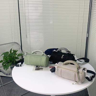 China Fashion hollowed out pillow handbag belt braided drawstring cylinder body bag fashion mesh material one shoulder bag small bag for sale