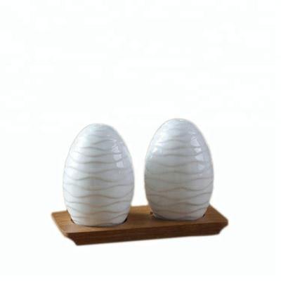 China Viable Miniature Wrinkled Funky Egg Shape White Ceramic Salt And Pepper Shaker Hand Made Set for sale